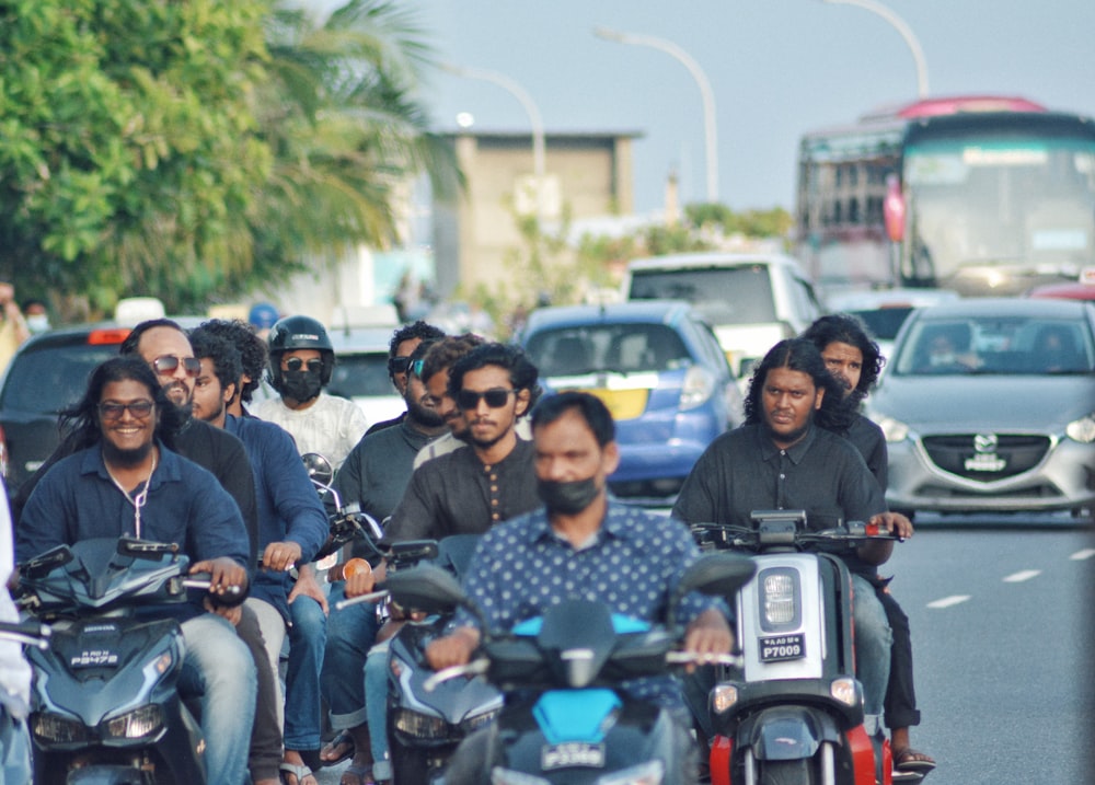 a group of people ride on motorcycles