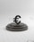 a black and white photo of a black and white object with a black circle on it