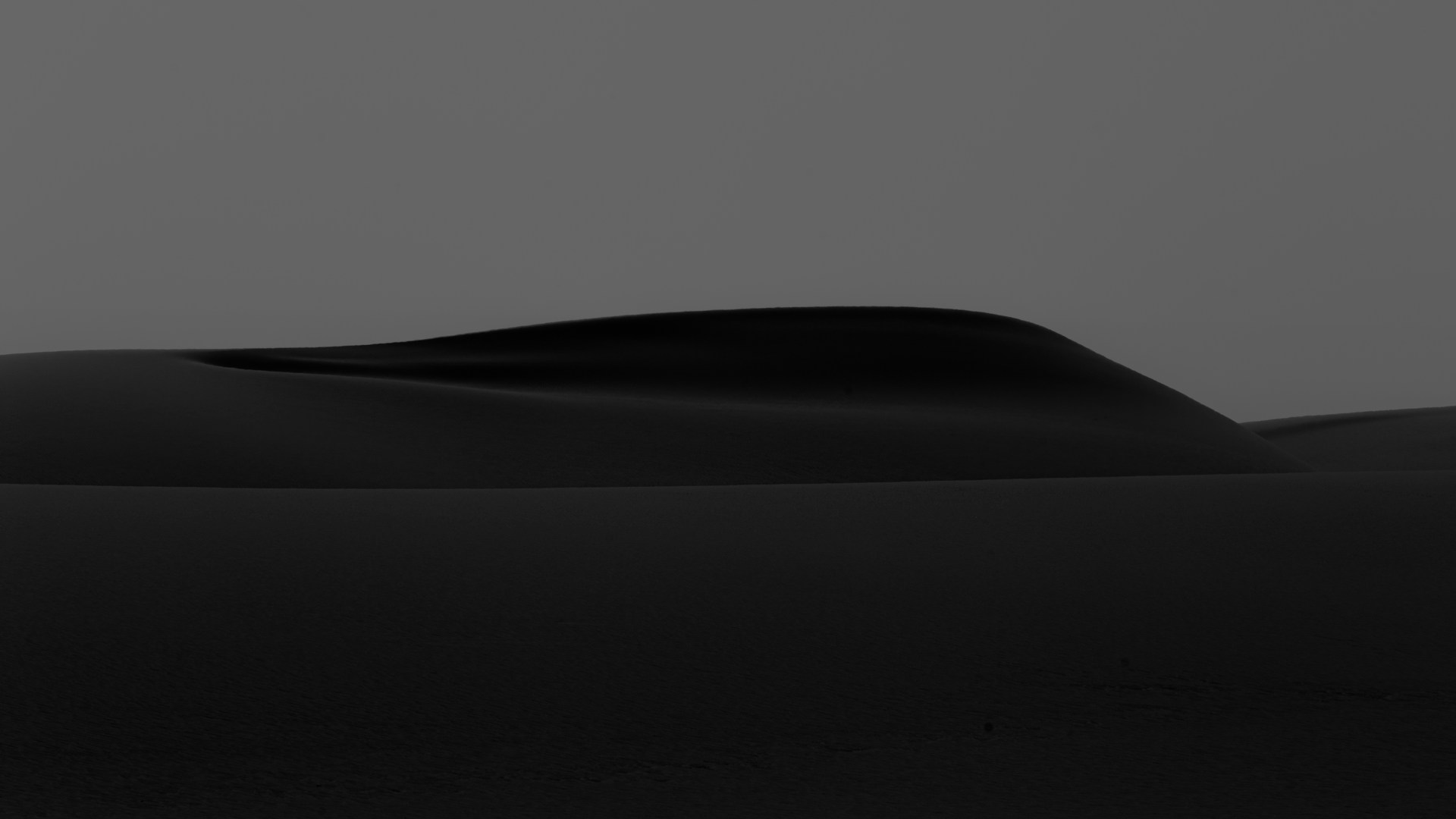 a large flat area with a hill in the background