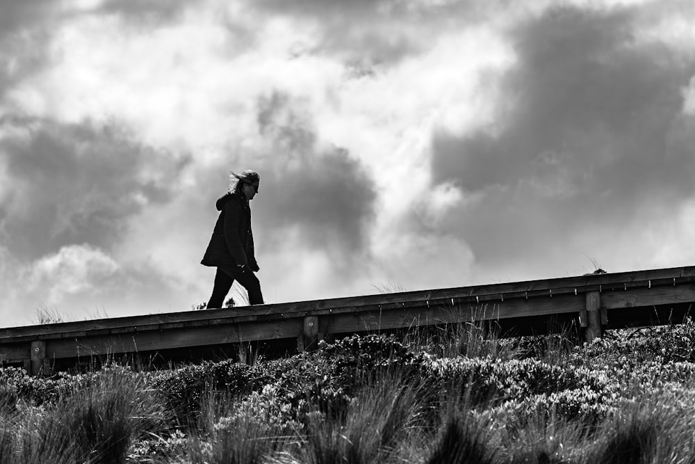 a person standing on a bridge