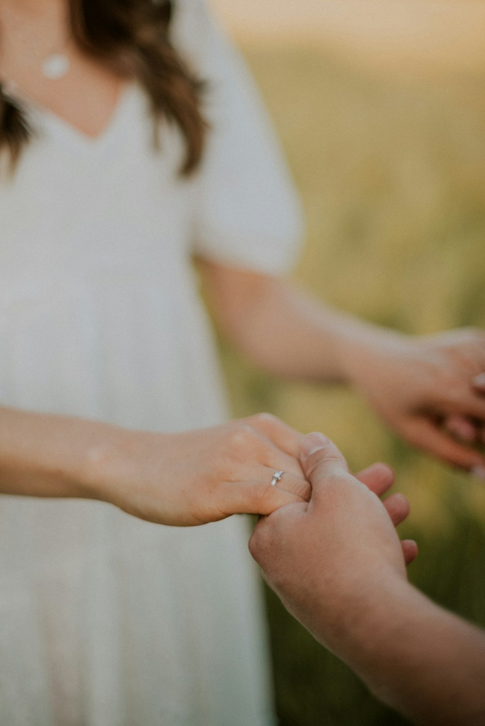 a woman holding a baby's hand