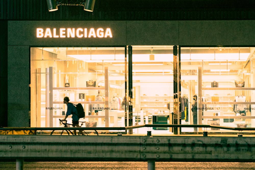 a person walking in front of a store window