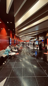 A cozy, modern cinema lobby at Penn Cinema Riverfront LLC with inviting seating and warm lighting.