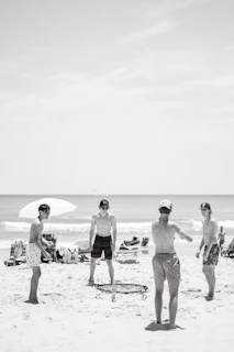 a group of people stand on a beach