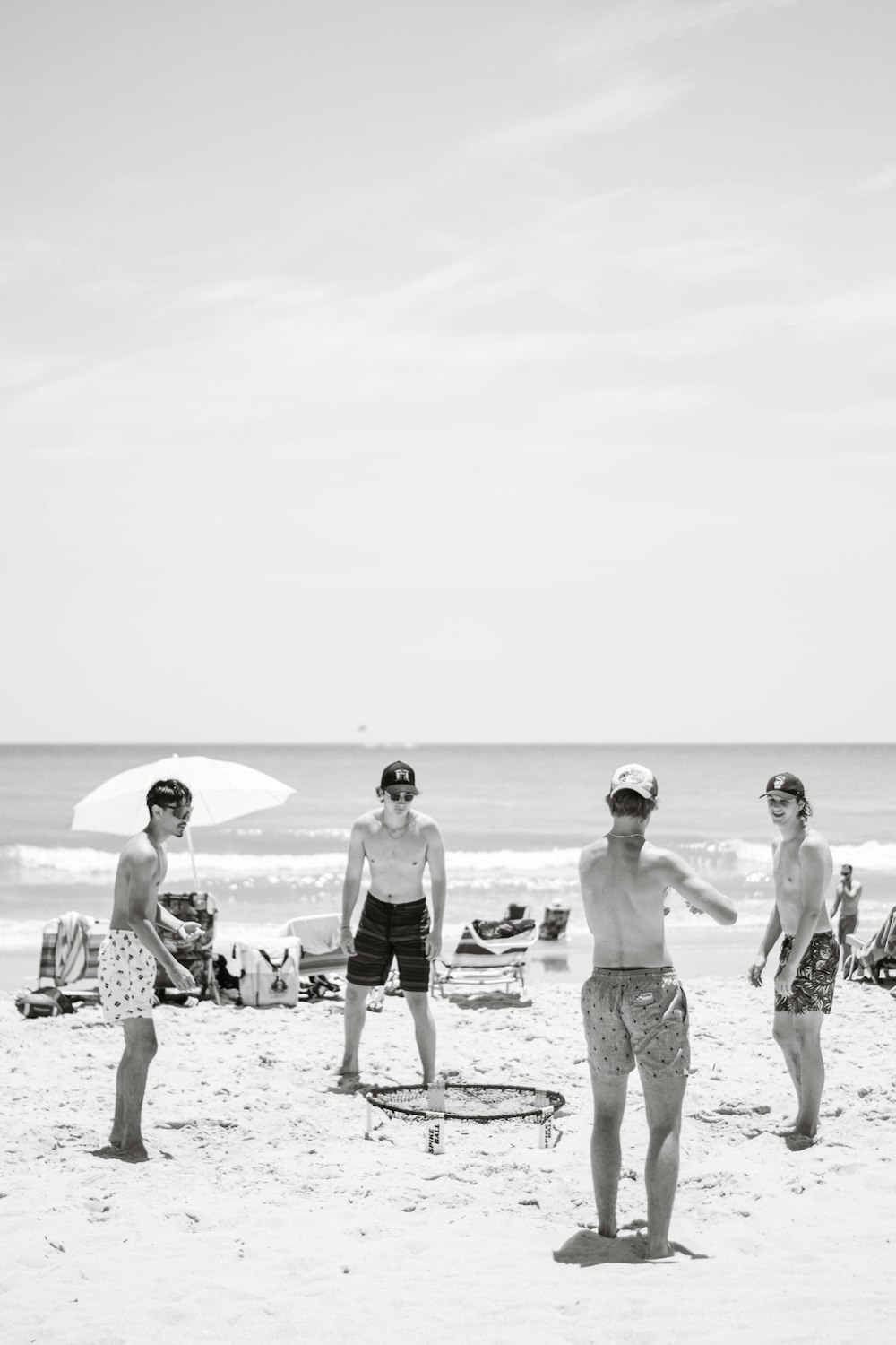a group of people stand on a beach