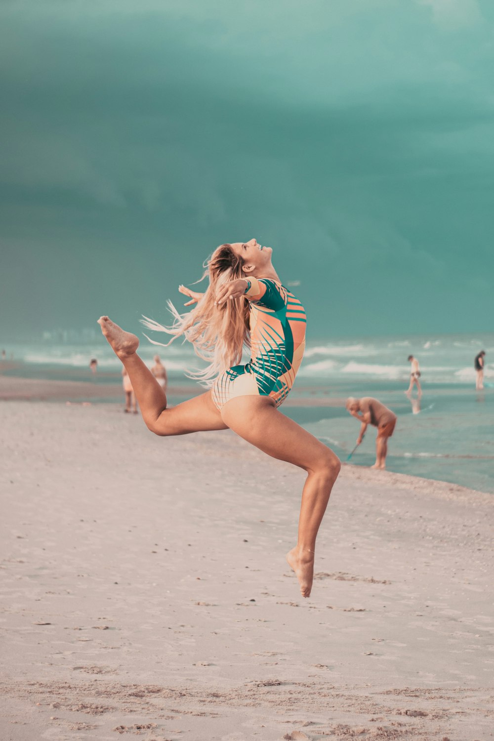 a person jumping on a beach