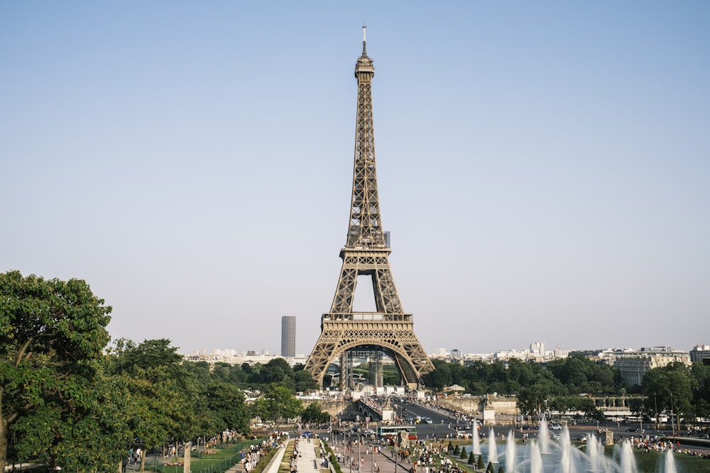 a tall metal tower with Eiffel Tower in the background