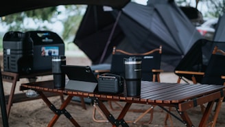 a table with a laptop and speakers