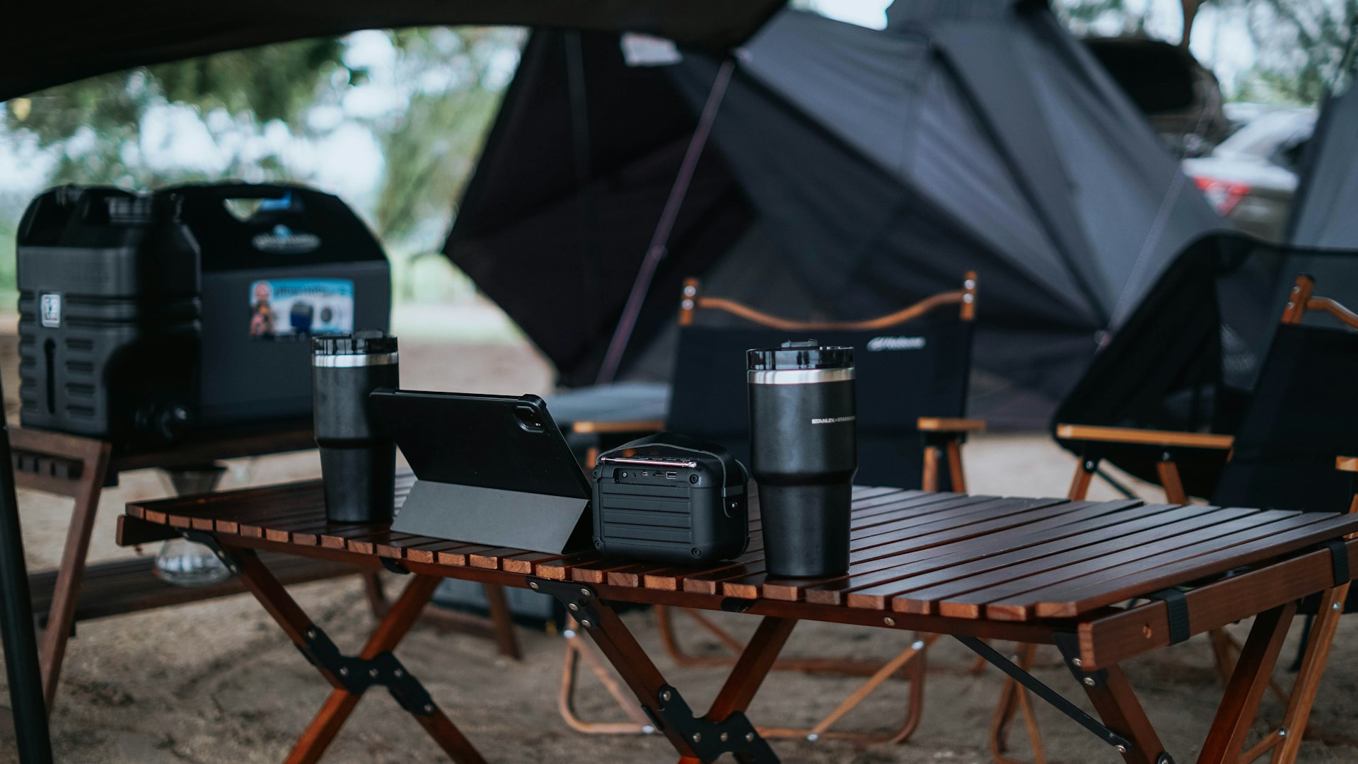 a table with a laptop and speakers