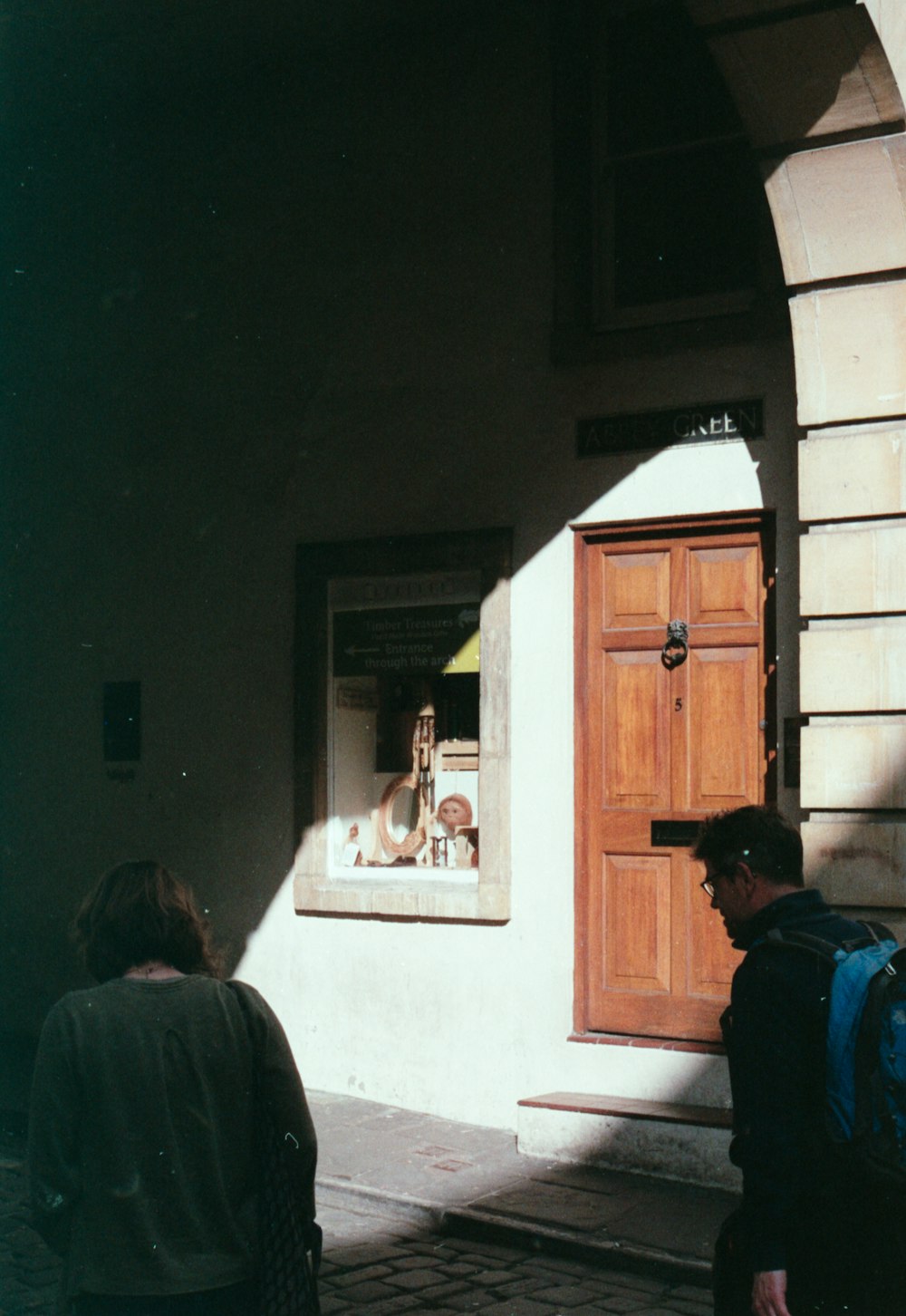 a man and woman walking down a sidewalk