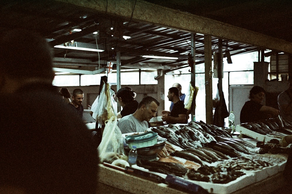 a group of people sitting at a table with food