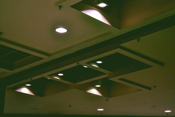 Custom 3D printed recessed smoke detector base installed seamlessly into a white ceiling with subtle shadows