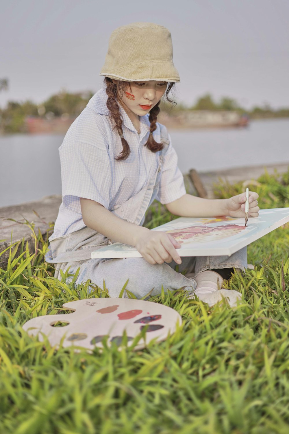 a woman sitting on a bench with a book and a clock