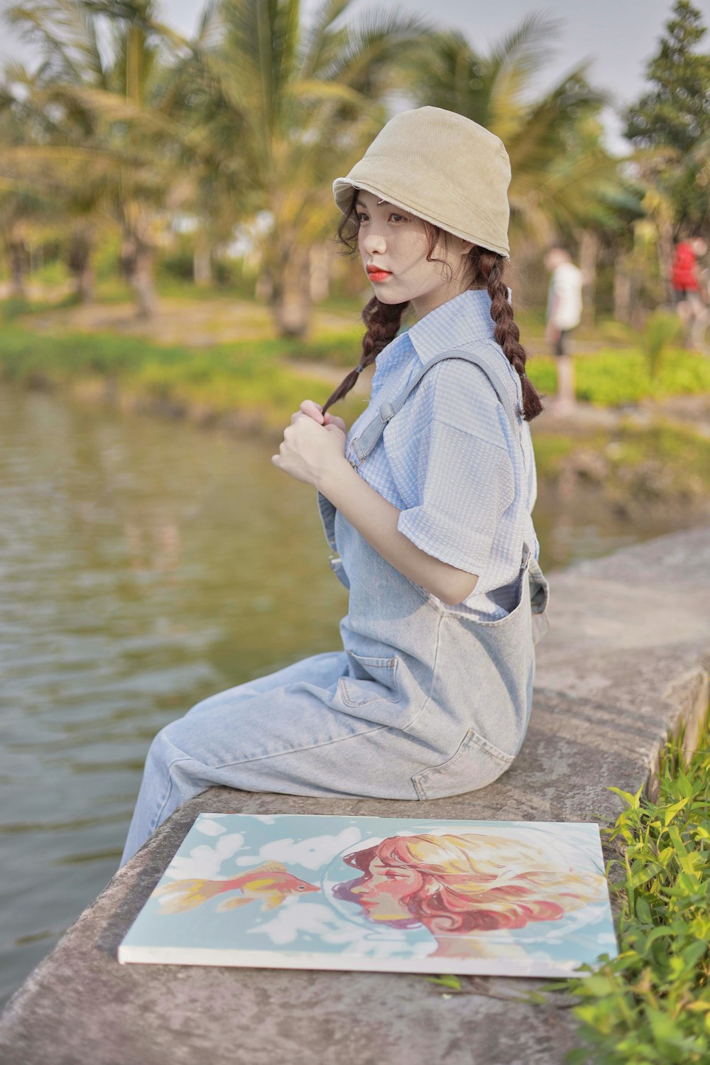 a person sitting on a rock by a river