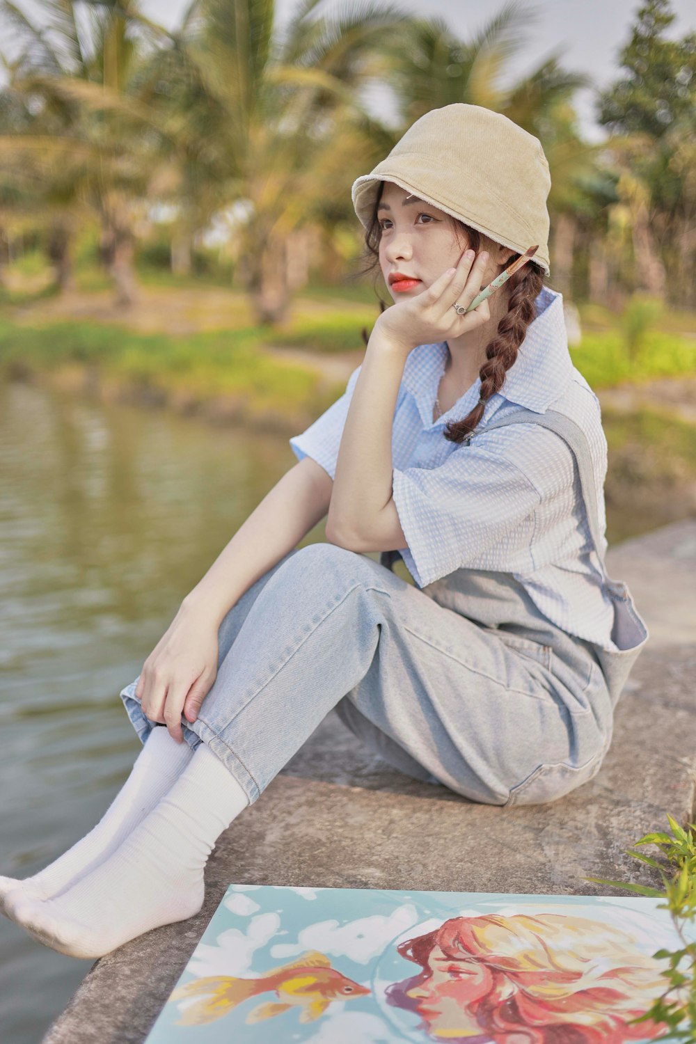 a person sitting on a rock by a river