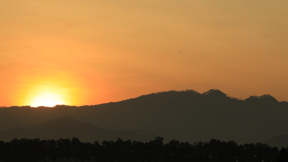 a sunset over a mountain range