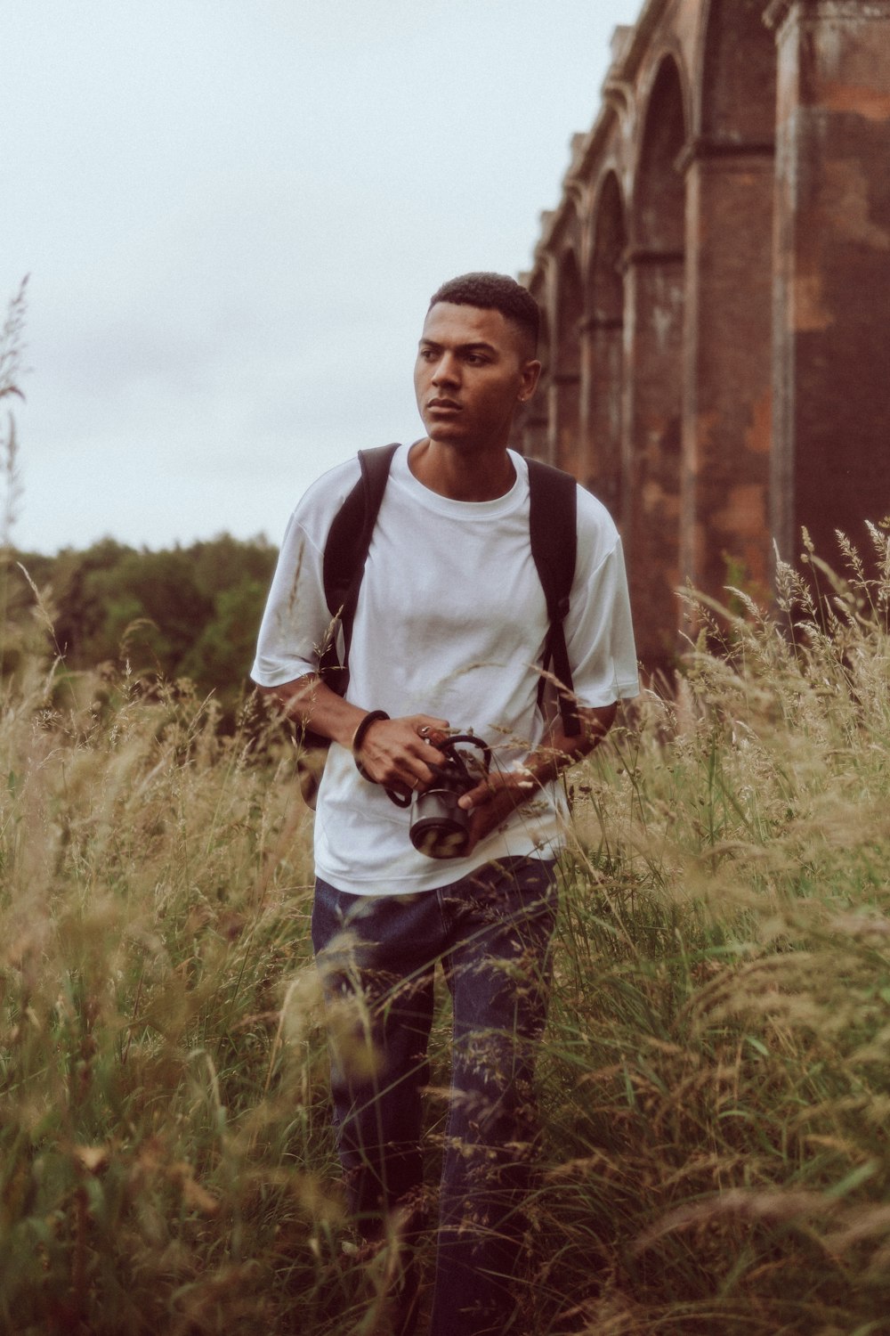 a man that is standing in the grass