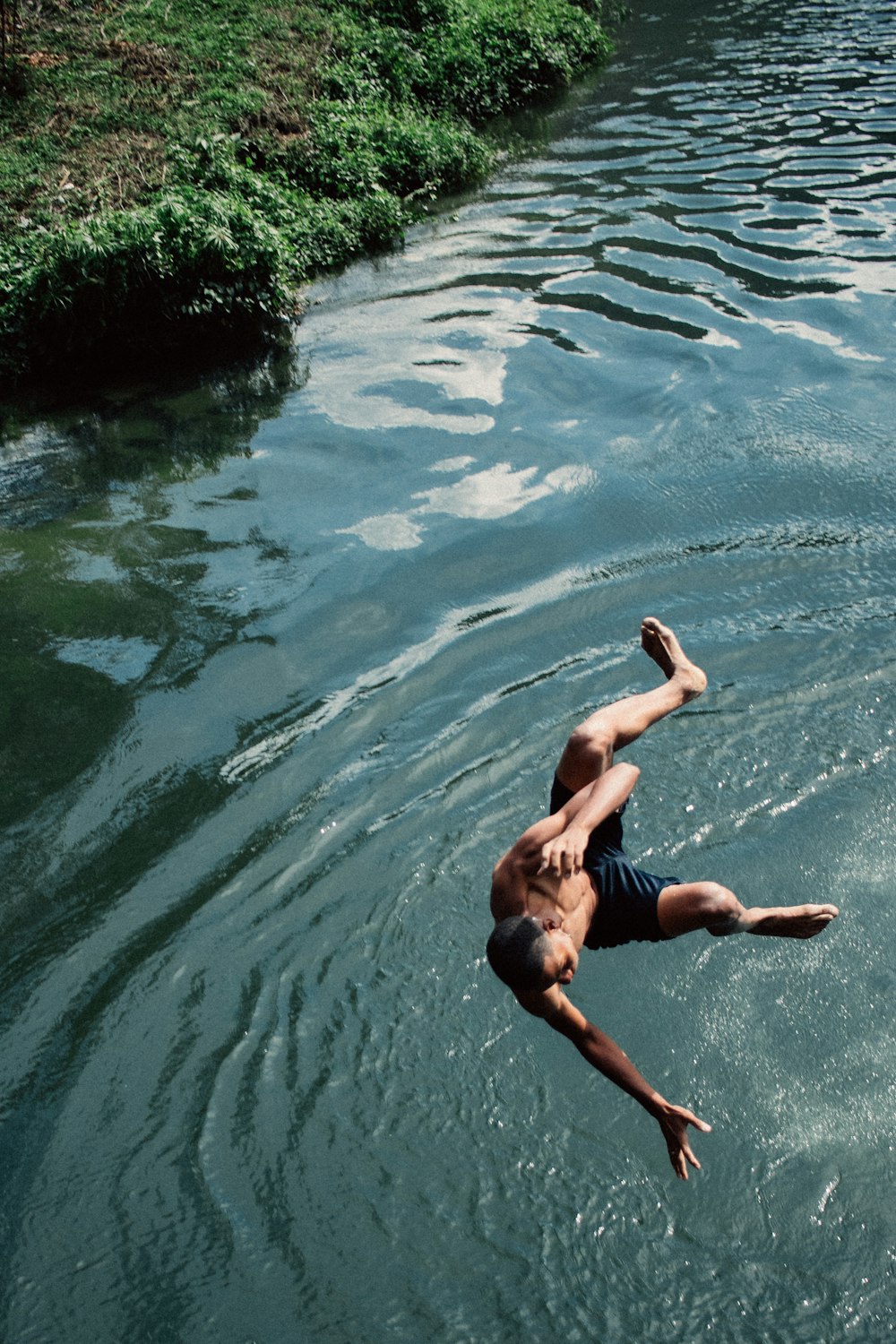 a person diving into a body of water