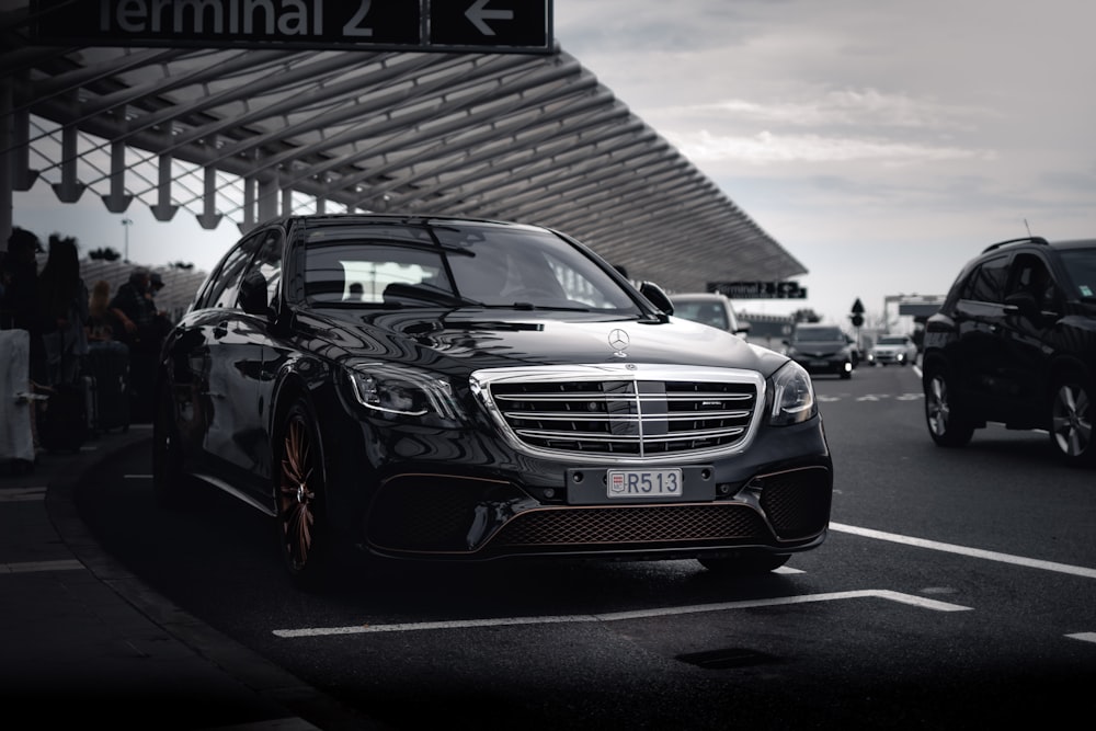 a black car parked in a parking lot