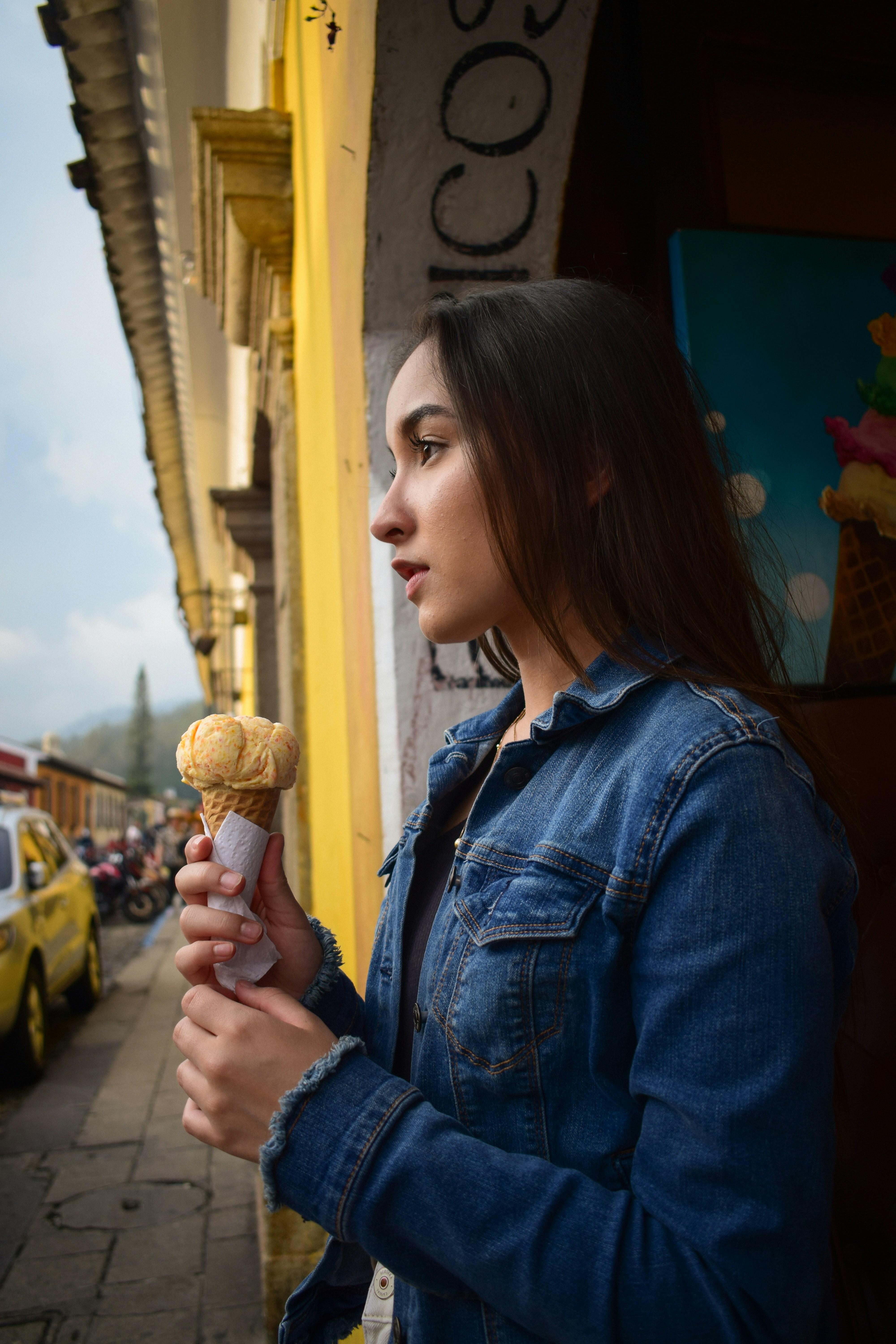 a person holding an ice cream cone