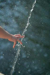 a hand holding a string of water