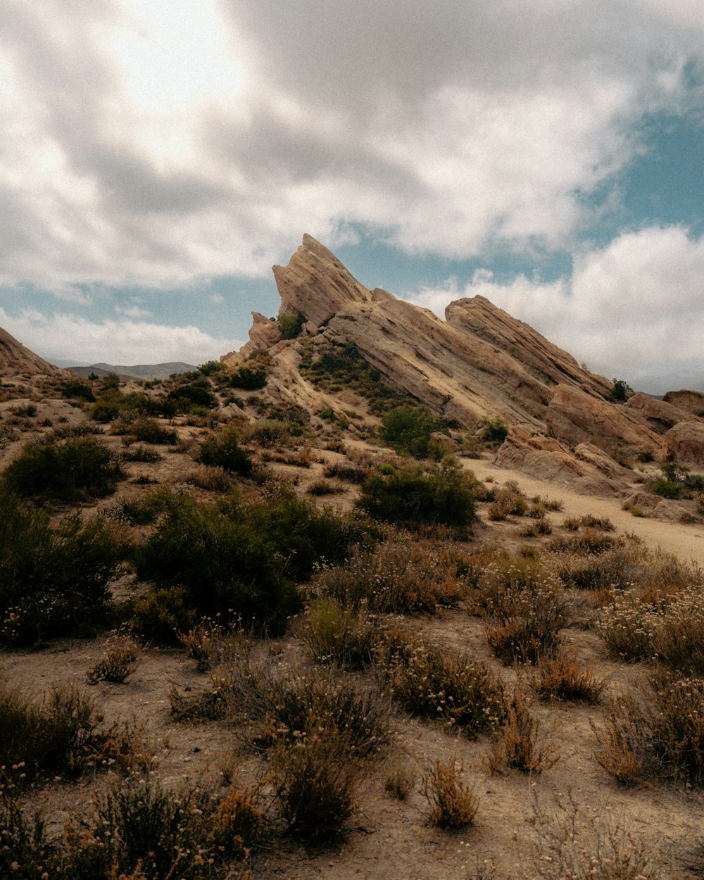 a desert landscape with a rocky mountain