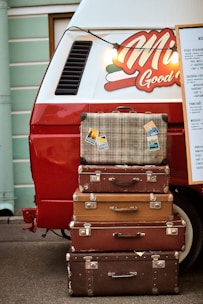 a stack of suitcases in front of a truck