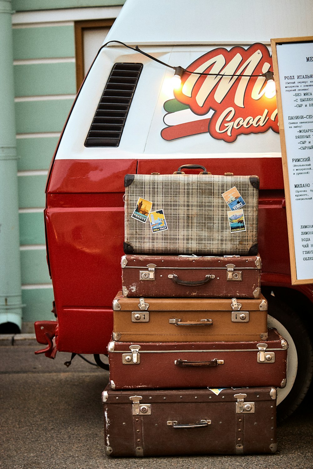 a stack of suitcases in front of a truck