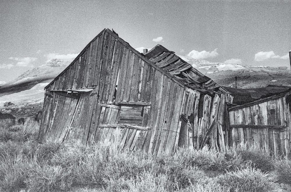 a wooden building in a field