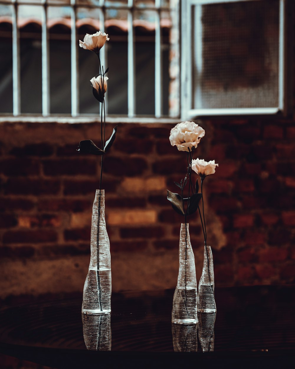 a couple of tall metal poles with flowers on them