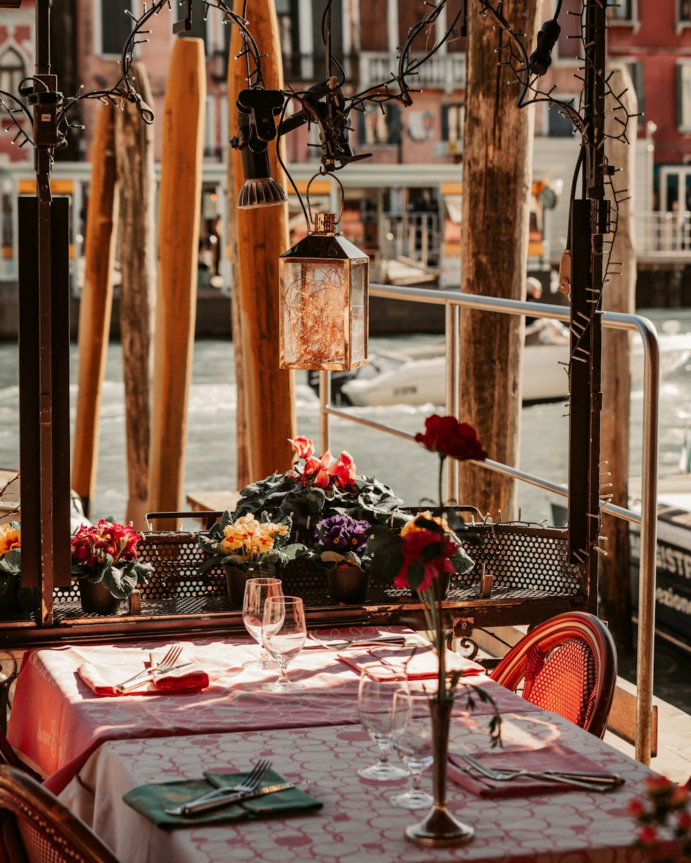 a table with flowers and glasses on it