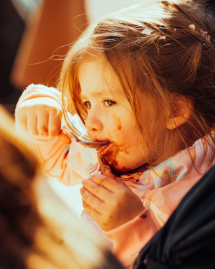 Close-up of a smiling baby enjoying a spoonful of nutritious homemade puree.