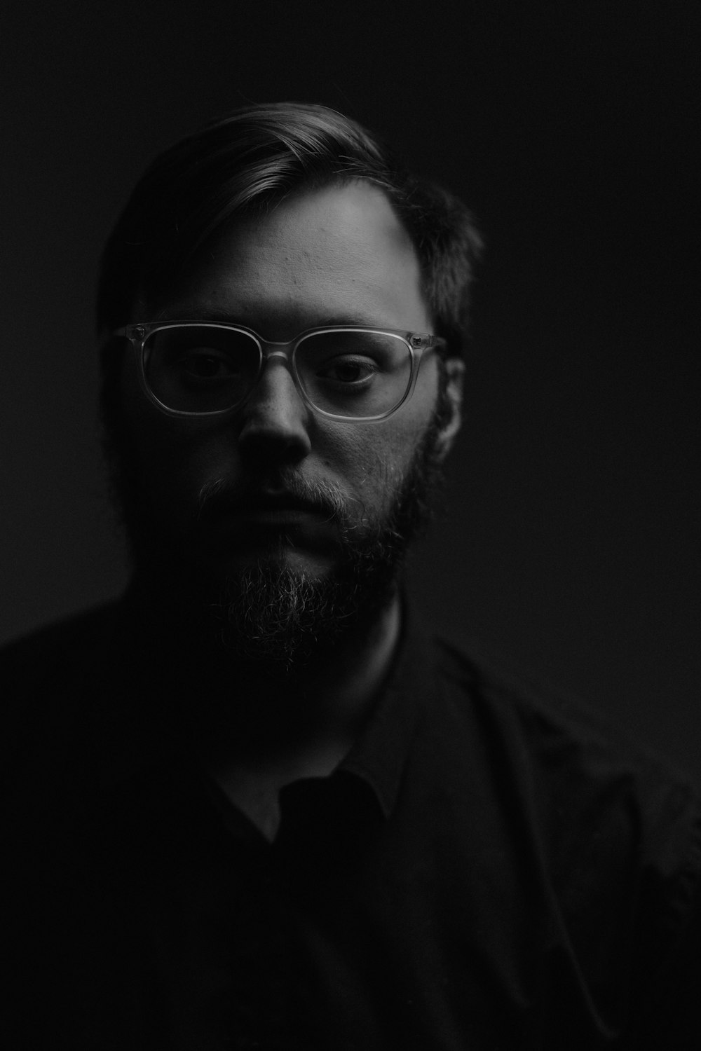 a man with a beard and glasses