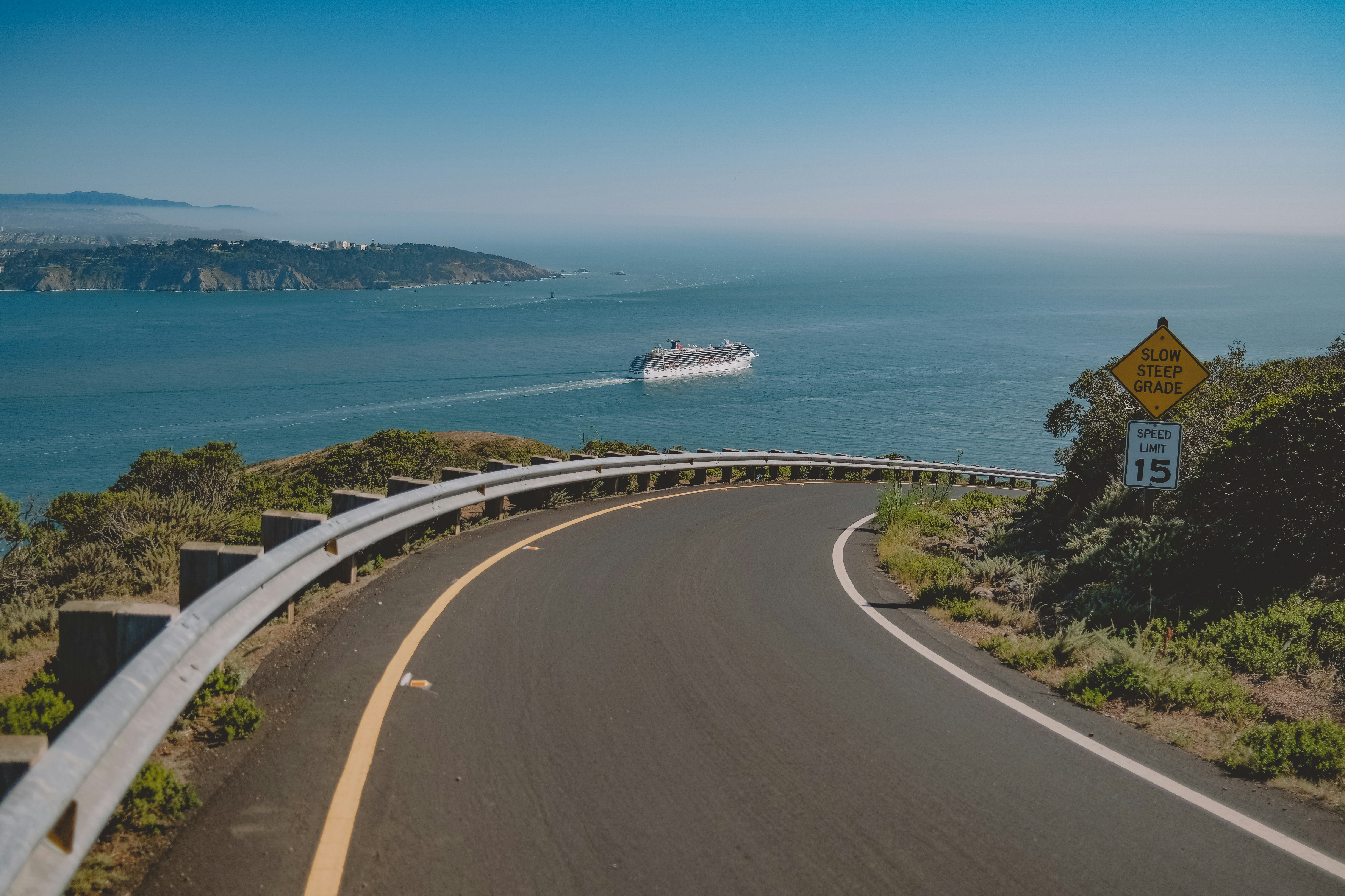 a road with a boat on it by a body of water