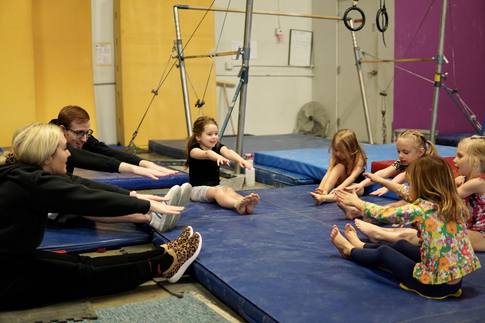 a group of people sitting on mats