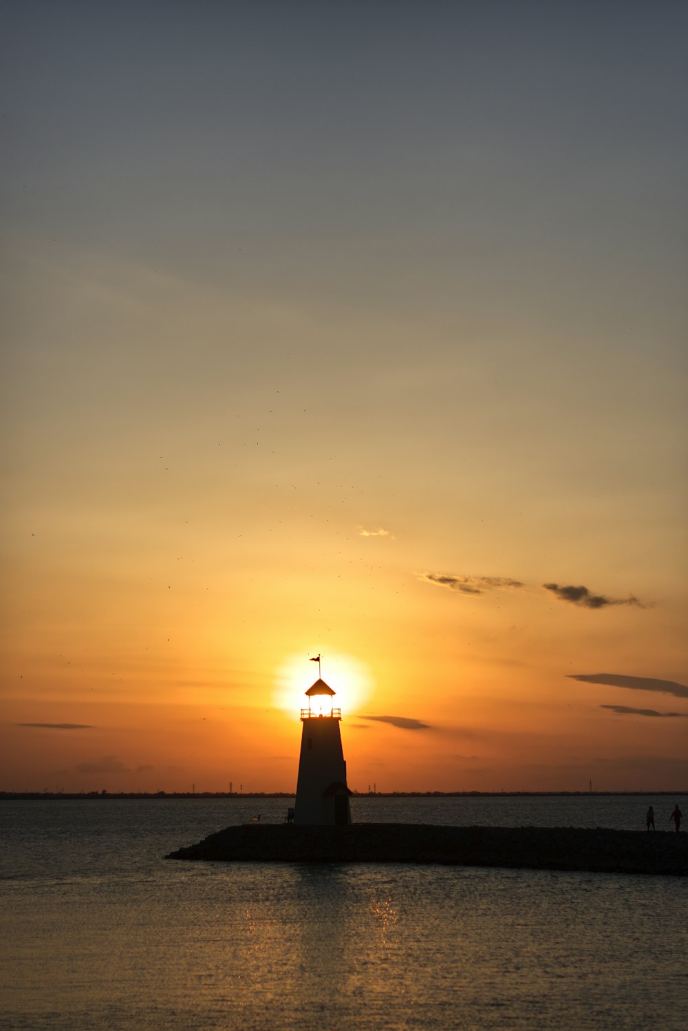 a lighthouse at sunset