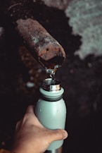 Rusty pipe and bottle, guide to waterfront property water quality.