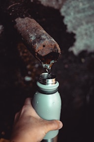 Rusty pipe and bottle, guide to waterfront property water quality.