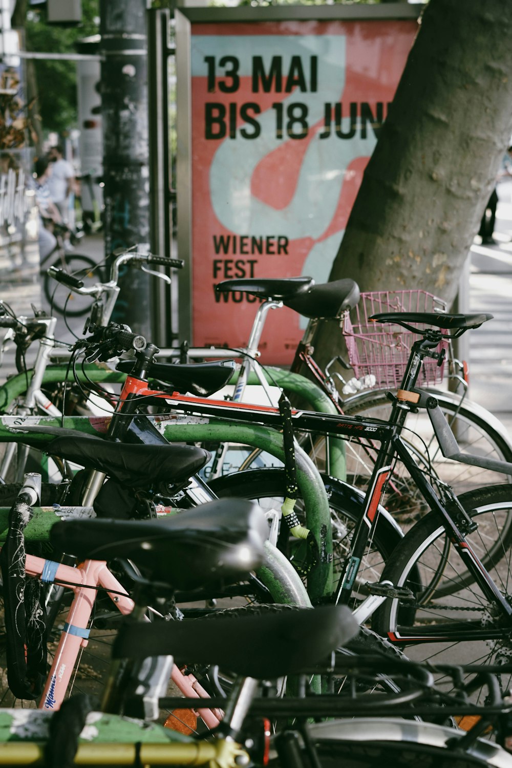 a group of bicycles parked next to a tree