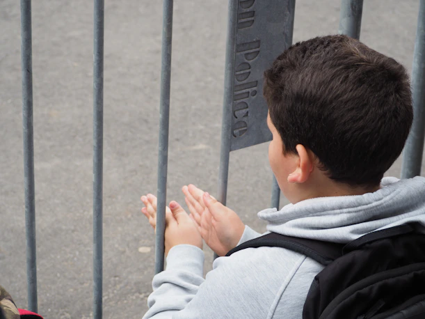 a boy holding his hands up