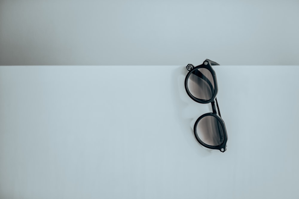 a pair of sunglasses on a white surface