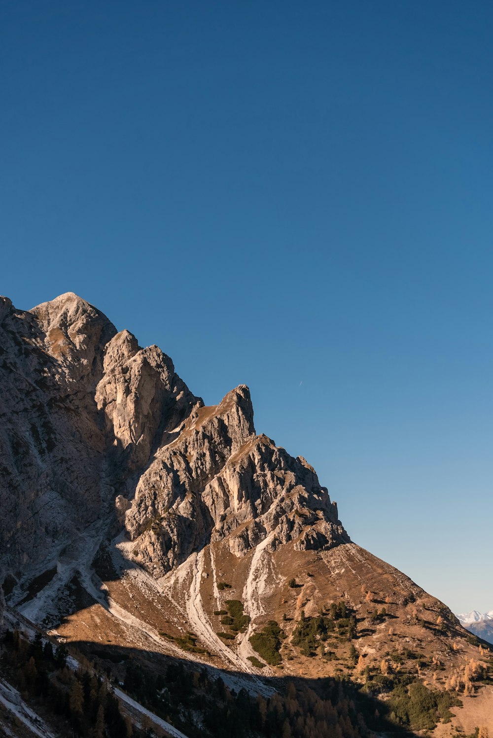 a rocky mountain with a blue sky