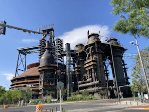 Industrial site with interconnected chemical processing units under deep blue sky.
