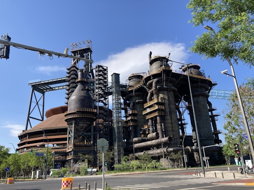 A panoramic view of a bustling copper cathode processing plant under a clear blue sky.