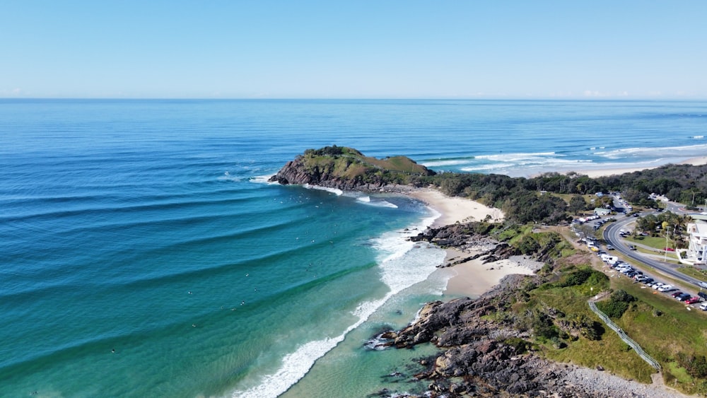 a beach with a road and a body of water