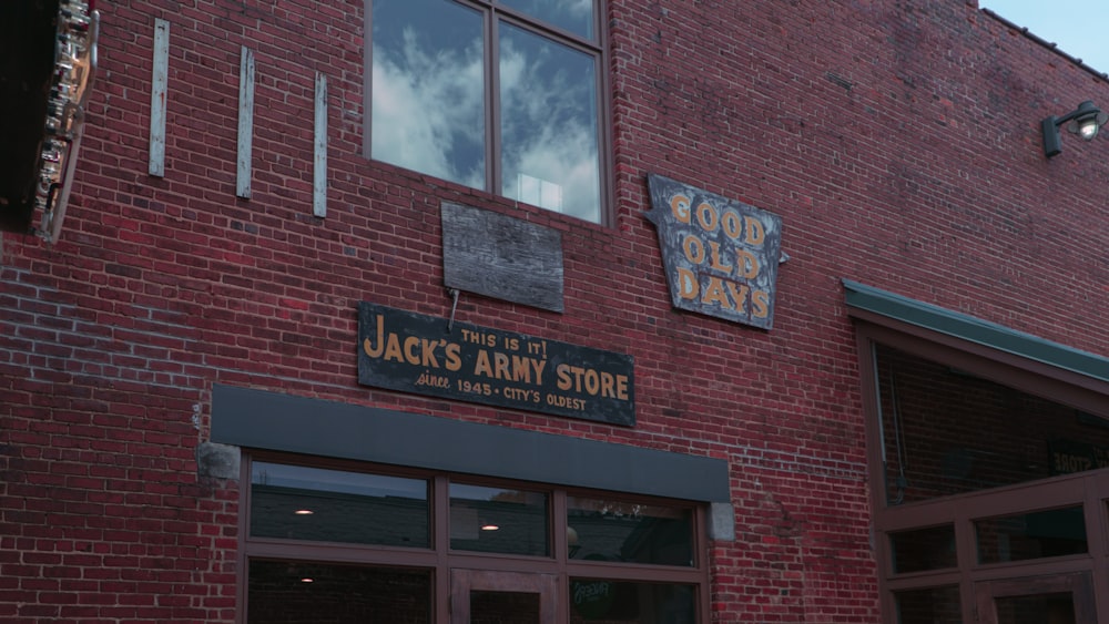 a brick building with signs on it