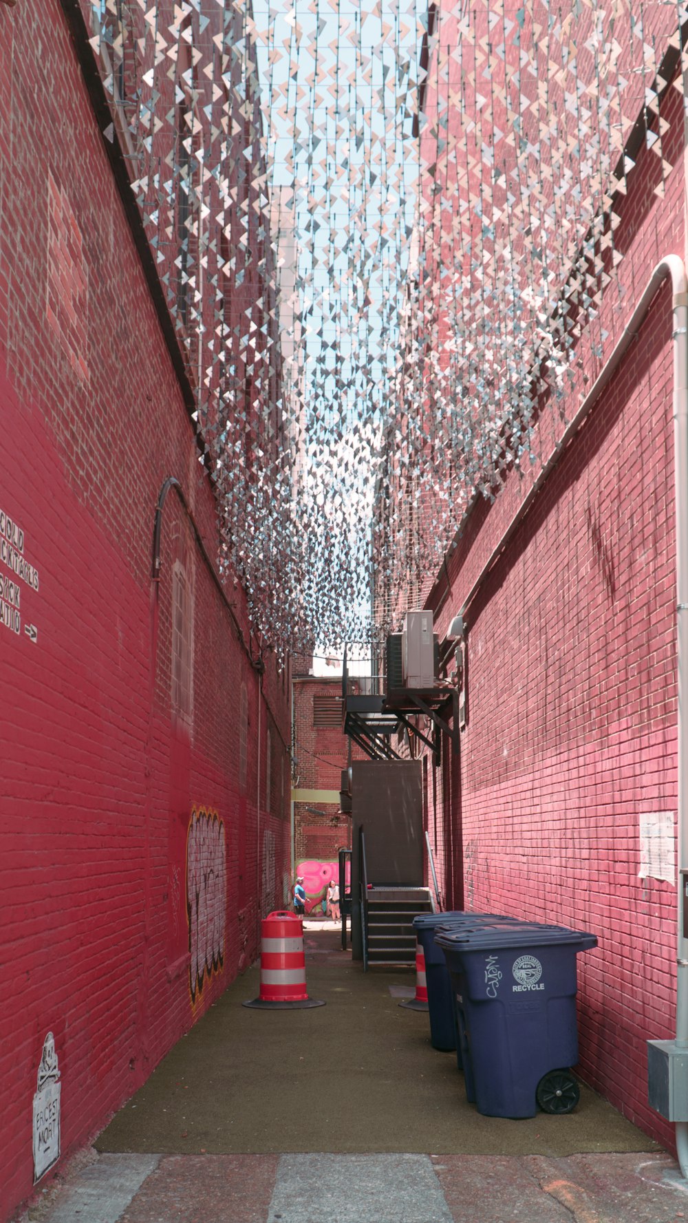 a brick building with a trash can