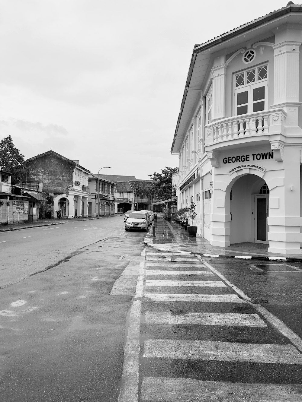 a black and white photo of a street with buildings on either side