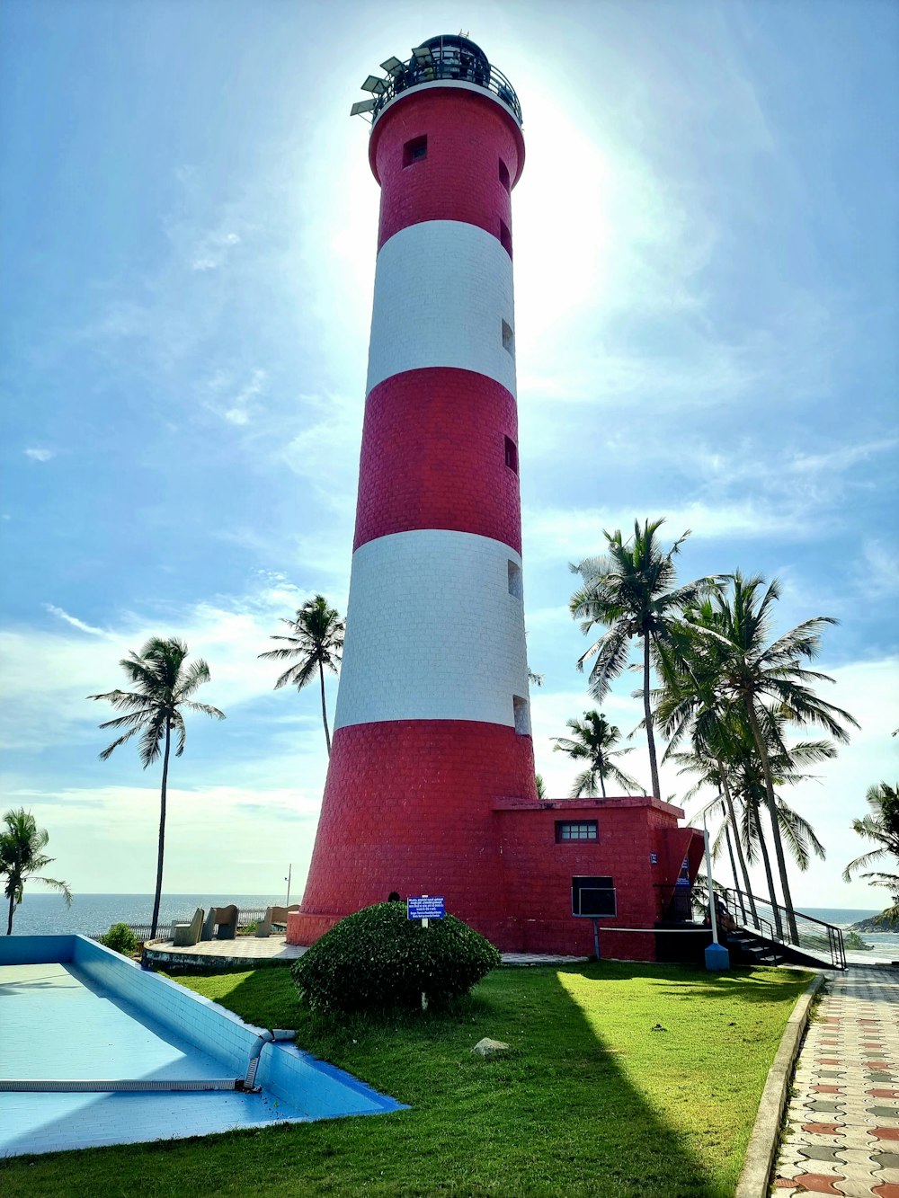 a lighthouse with a red and white striped top