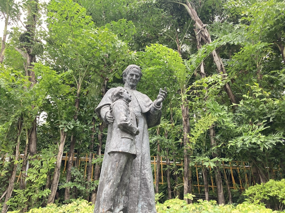 a statue of a person in a forest